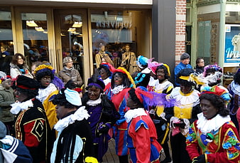 Group of people in traditional Sinterklaas costumes on street