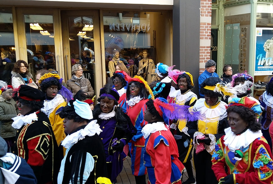 Group of people in traditional Sinterklaas costumes on street