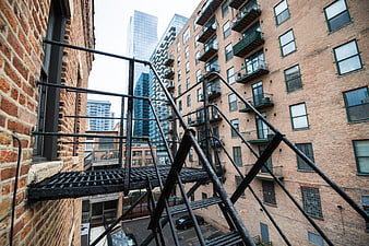 Urban Fire Escape Staircase Between Brick Buildings