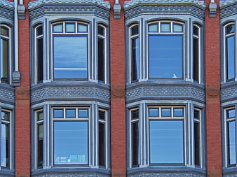 Symmetrical Red Brick Building Facade with Ornate Windows