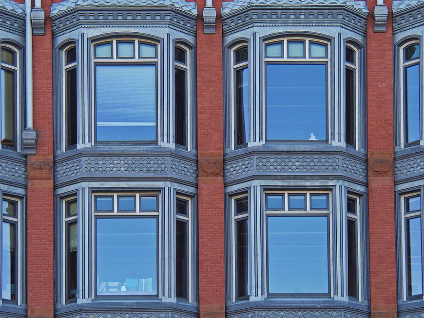 Symmetrical Red Brick Building Facade with Ornate Windows