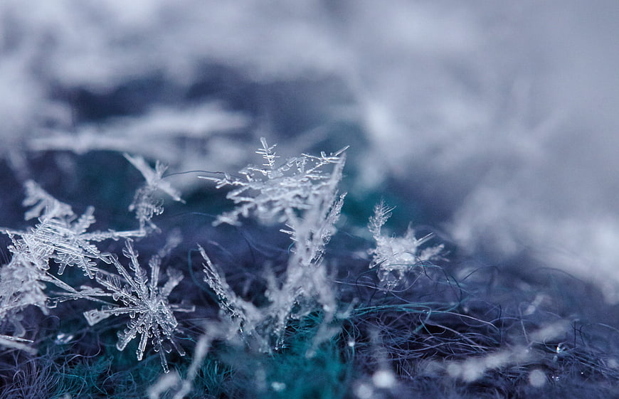 Macro Close-Up of Intricate Ice Crystals on Blue Fabric