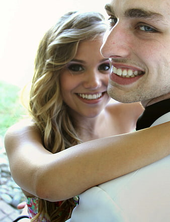 Happy Young Couple Smiling and Hugging Outdoors