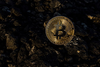 Gold Bitcoin on Dark Rocks