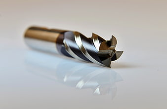 Close-up of a CNC milling cutter end mill on a white surface