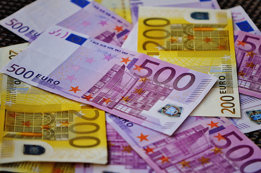 Scattered 500 and 200 Euro Banknotes on Dark Surface