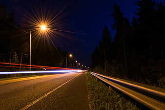 Night highway with long exposure car light trails