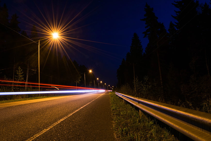 Night highway with long exposure car light trails