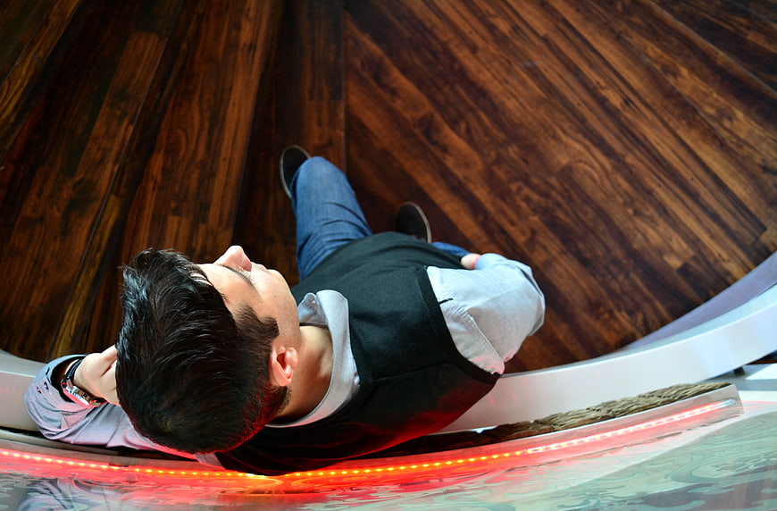 Man taking selfie with fisheye lens on wooden floor