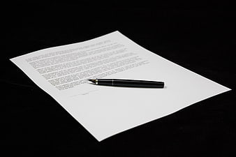 Black fountain pen on signed document with contract text