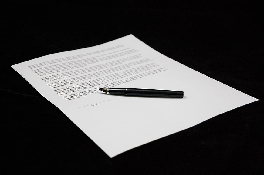 Black fountain pen on signed document with contract text