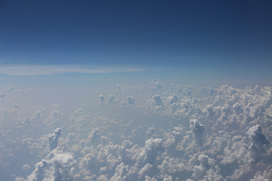Aerial View of Fluffy White Clouds Under Blue Sky