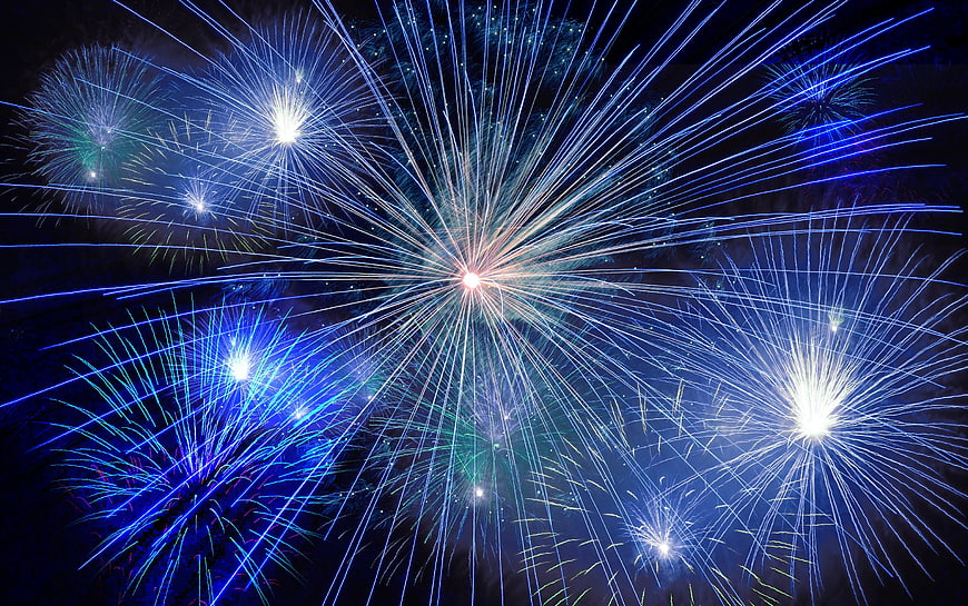 Blue and White Fireworks Exploding in Night Sky