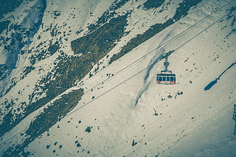 Aerial view of cable car on snowy mountain slope