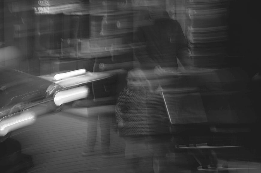 Abstract black and white motion blur of family walking
