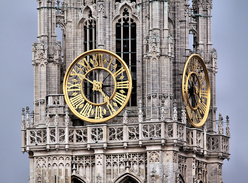 Gothic Cathedral Clock Tower with Golden Dials