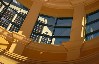 Low angle view of beige architectural columns and windows