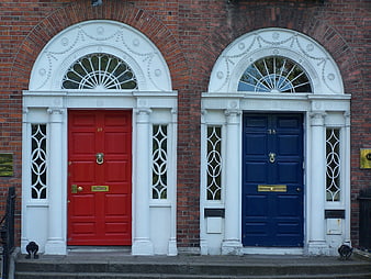 Red and Blue Georgian Doors on Brick Facade