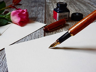 Wooden Fountain Pen on Blank Paper with Rose