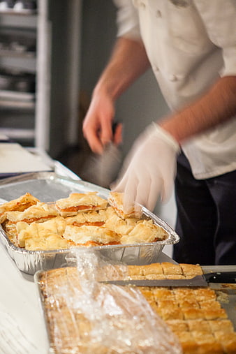 Chef preparing savory pastries in commercial kitchen