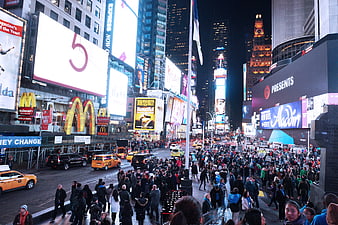 Crowded Times Square NYC Night with Bright Billboards