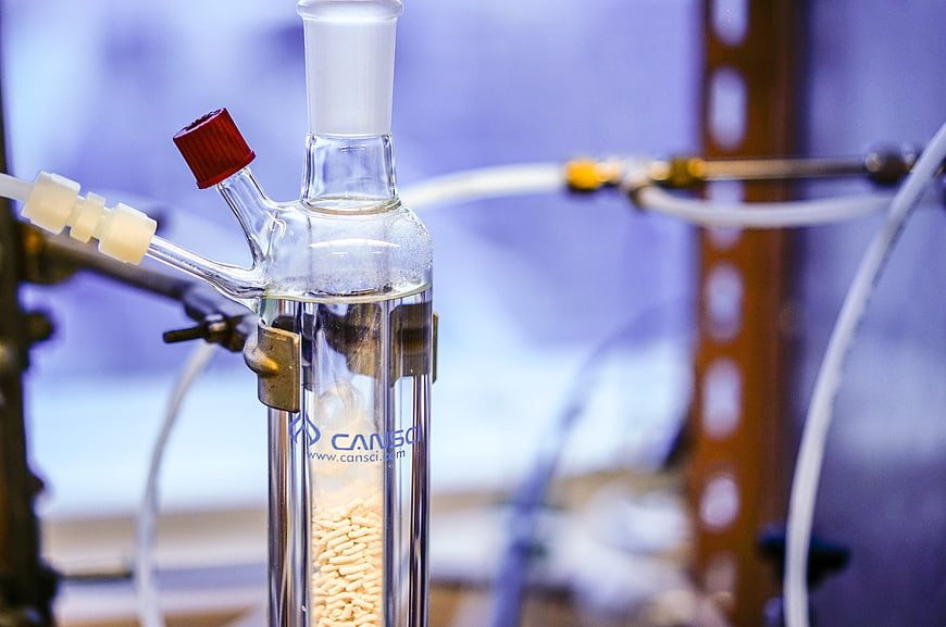 Close-up of laboratory glassware with chemical reaction