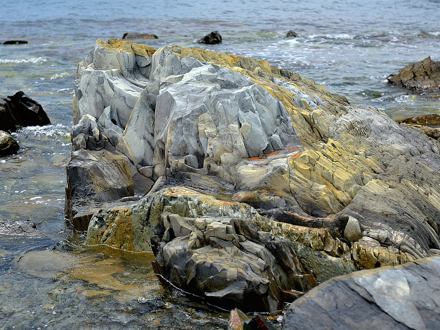 Textured coastal rock formation in ocean water