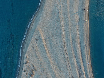 Aerial view of sandy spit between turquoise waters