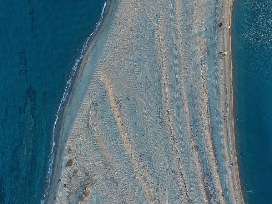 Aerial view of sandy spit between turquoise waters