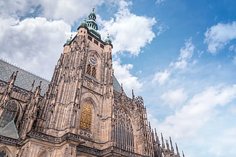 Gothic Cathedral Tower Against Blue Sky with Clouds