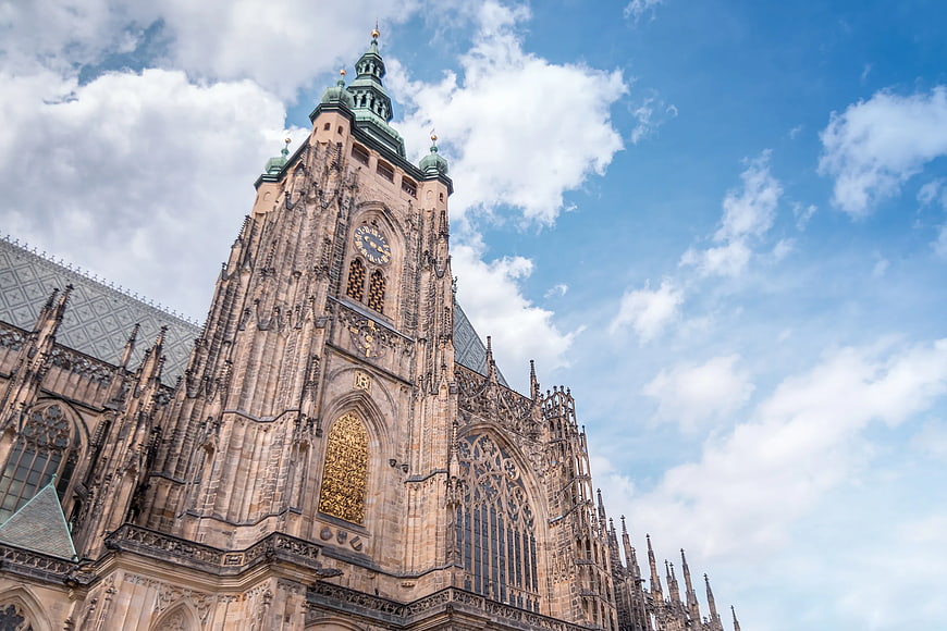 Gothic Cathedral Tower Against Blue Sky with Clouds