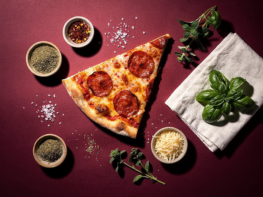 Pepperoni Pizza Slice with Herbs and Spices Flat Lay