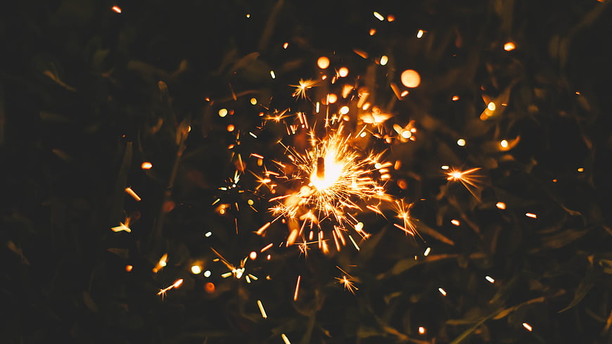 Sparkler Burning at Night with Golden Sparks