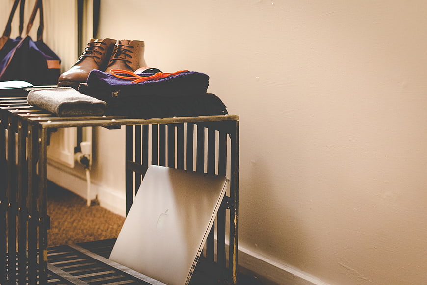 Laptop and boots on industrial crate table with copyspace