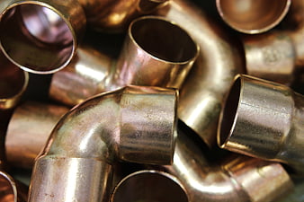Close-up of shiny copper plumbing fittings and pipes