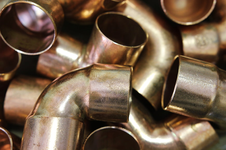 Close-up of shiny copper plumbing fittings and pipes