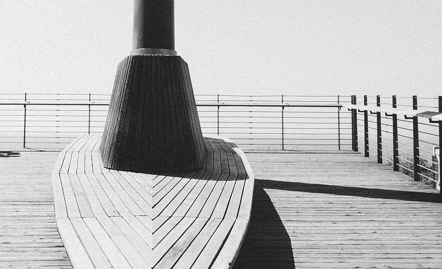 Black and white architectural detail of wooden deck and railing