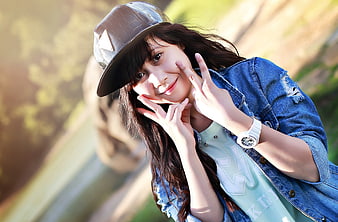 Happy Asian Teenage Girl Wearing Cap and Denim Jacket Outdoors