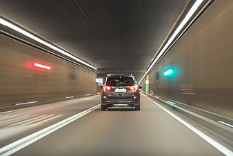 Car driving fast through tunnel with motion blur