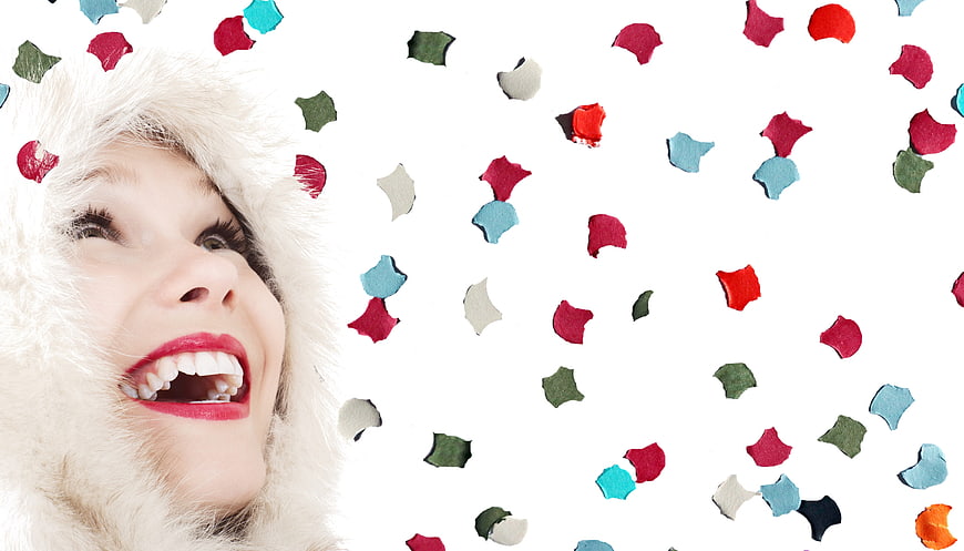 Happy Woman Laughing with Confetti on White Background