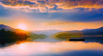 Serene Lake Sunset with Mountains and Raft Reflection