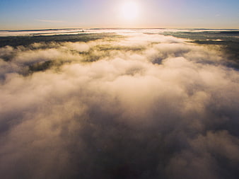 Aerial View of Golden Sunlight Breaking Through Thick Morning Fog