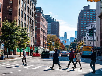 Pedestrians Crossing City Street in Autumn