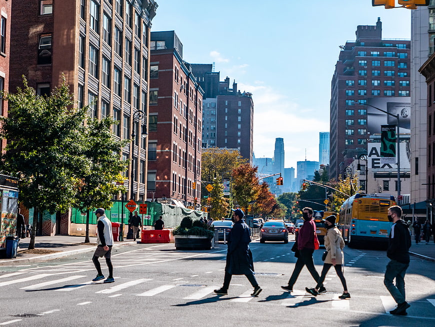 Pedestrians Crossing City Street in Autumn