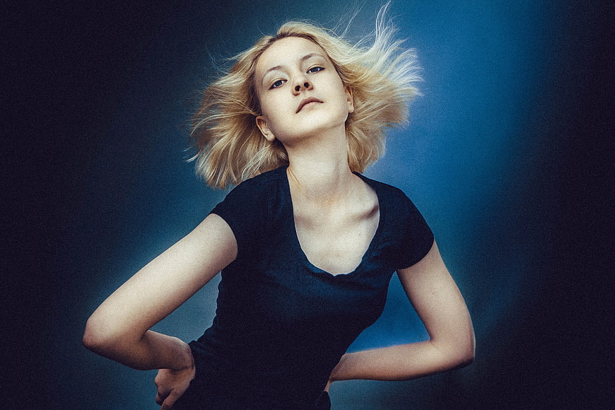Blonde Woman with Windblown Hair in Black Shirt