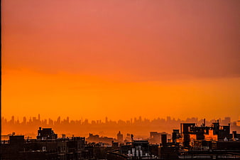 Vibrant Orange Sunset Over Urban City Skyline