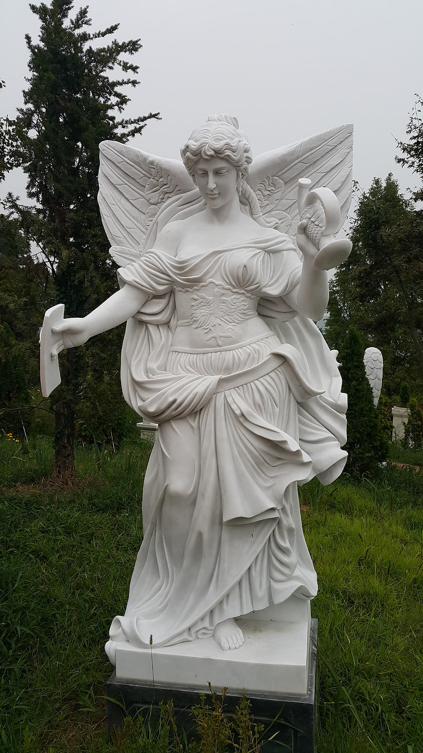 White Marble Angel Statue in Garden