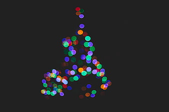 Abstract Christmas Tree Made of Colorful Bokeh Lights on Dark Background