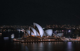 Sydney Opera House illuminated at night with city skyline
