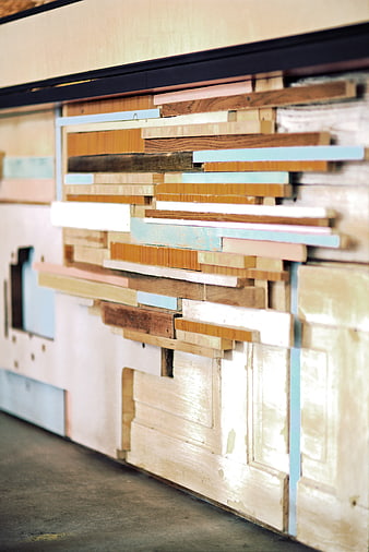 Stacked wooden planks and furniture parts in workshop